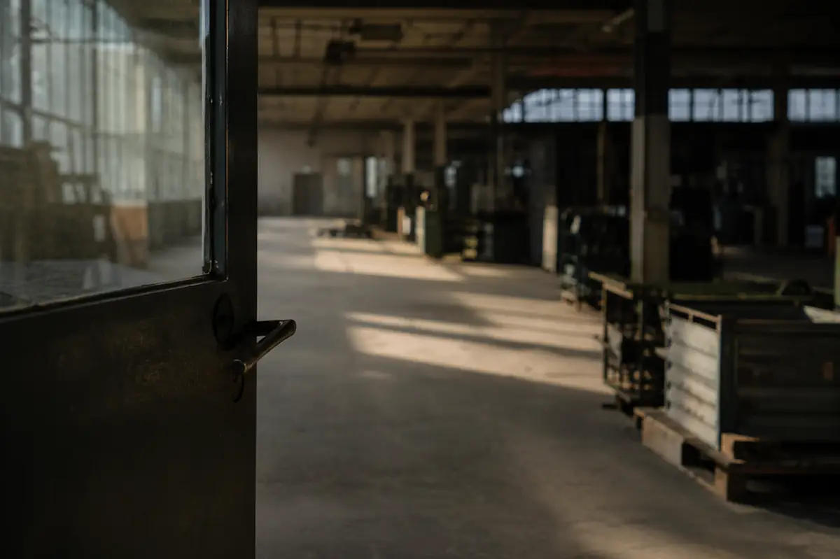 View through an open shop door into a hall in backlight